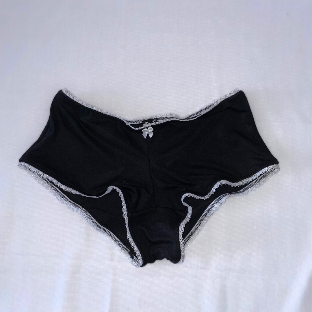 This image features the Daphne Bootyshort in Solids, showcasing a sleek and sophisticated design. The bootyshort is crafted from a high-quality, soft rayon lycra blend, presenting a comfortable and buttery-soft feel.