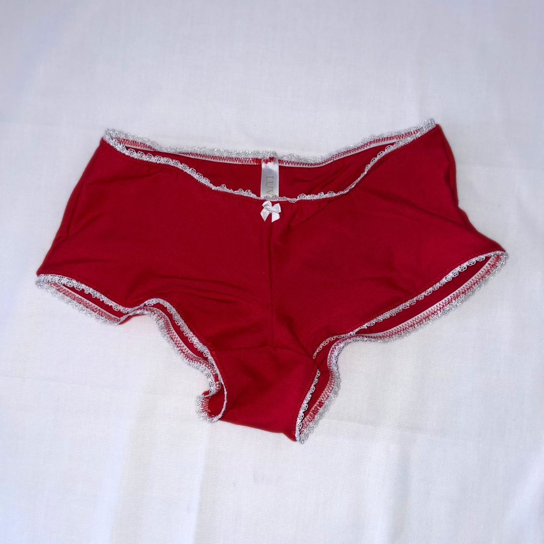 This image features the Daphne Bootyshort in Solids, showcasing a sleek and sophisticated design. The bootyshort is crafted from a high-quality, soft rayon lycra blend, presenting a comfortable and buttery-soft feel.